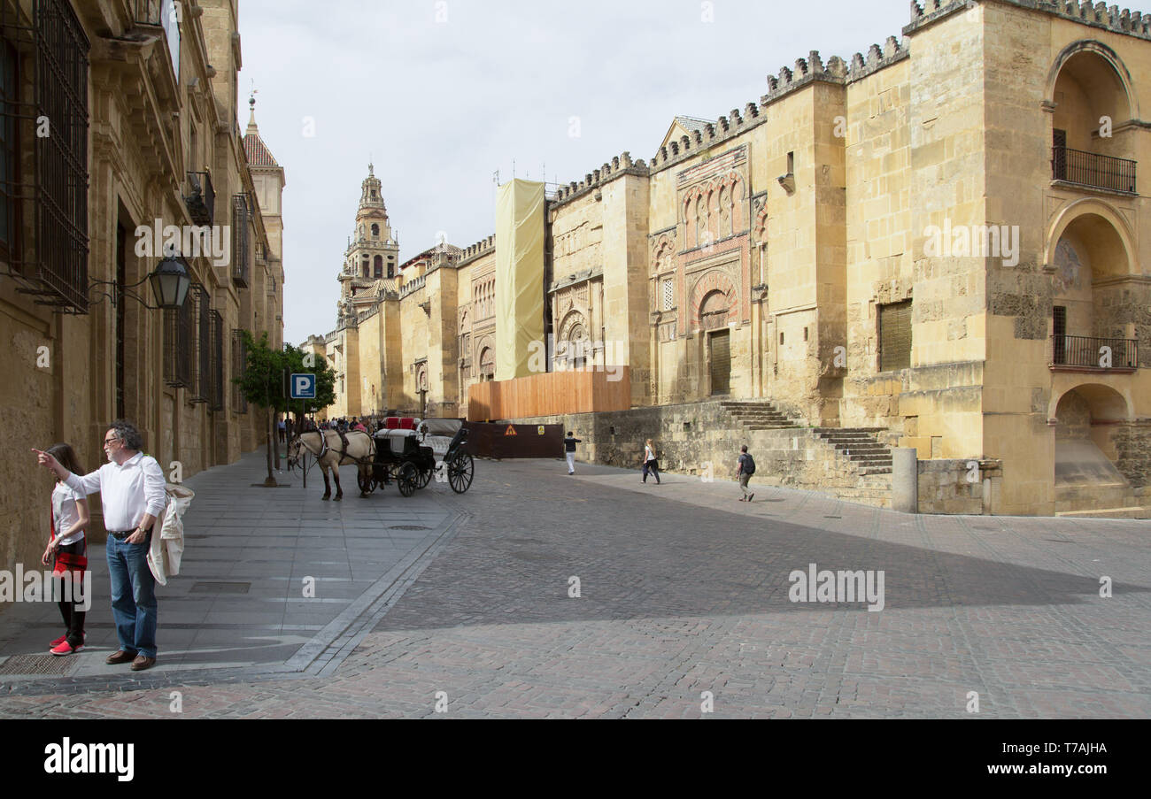CORDOBA, SPAIN - APR, 25: tourists walking on Cordoba street near mosque on April, 25, 2014 in Cordoba, Spain Stock Photo