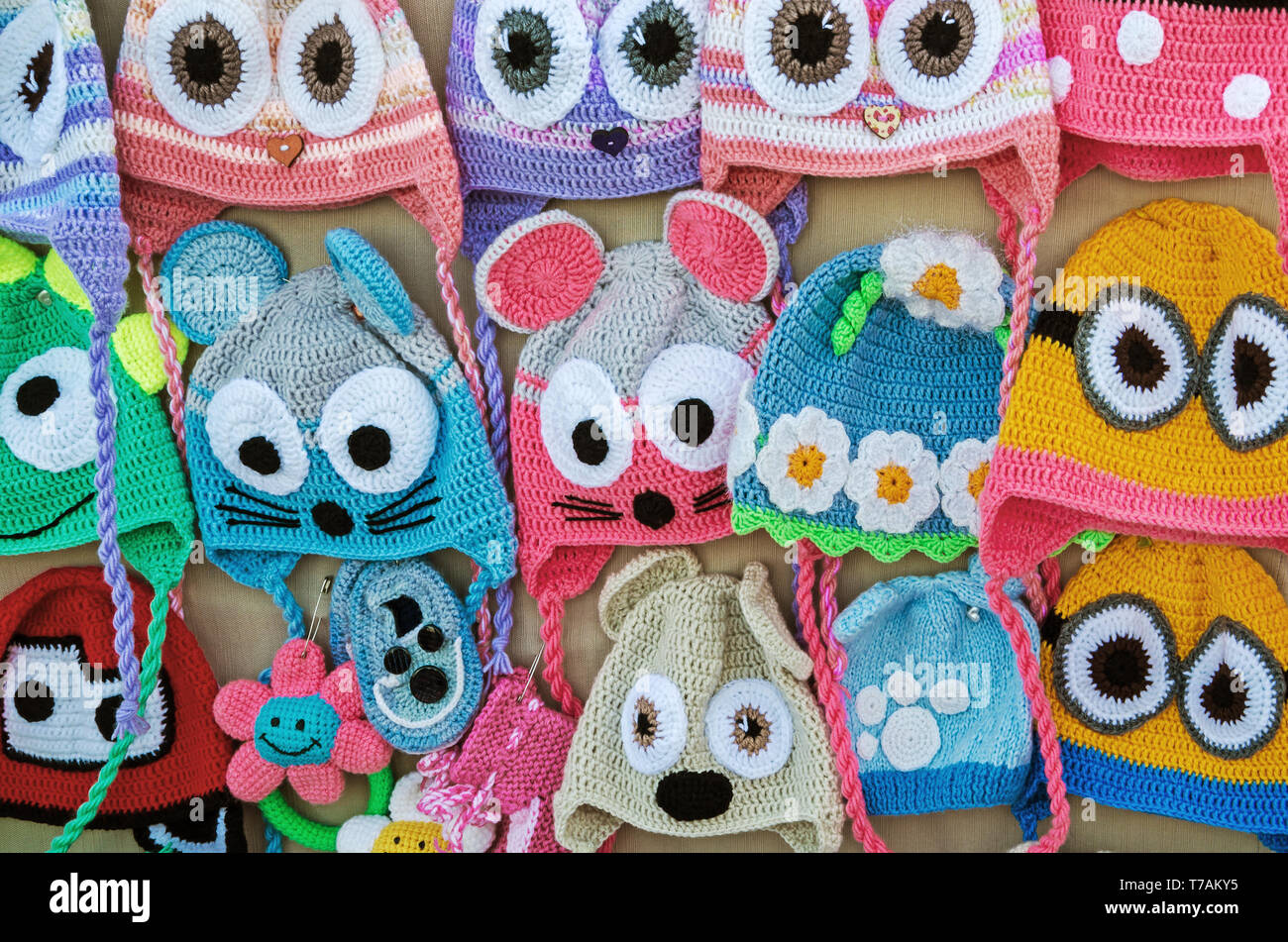 A set of children's knitted hats handicraft in form of funny little animals  Stock Photo - Alamy