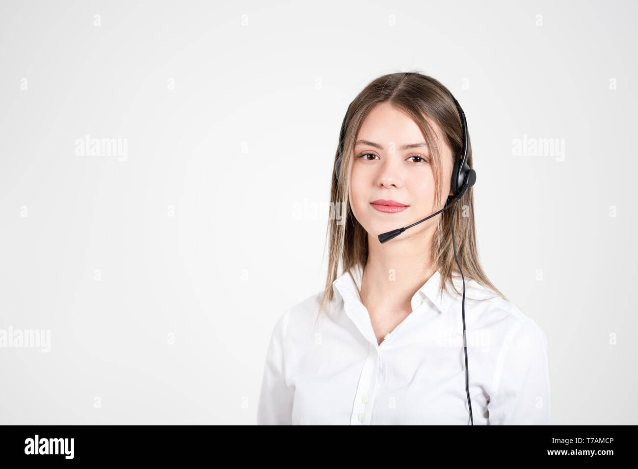 Female consulting manager with headset on light background Stock Photo