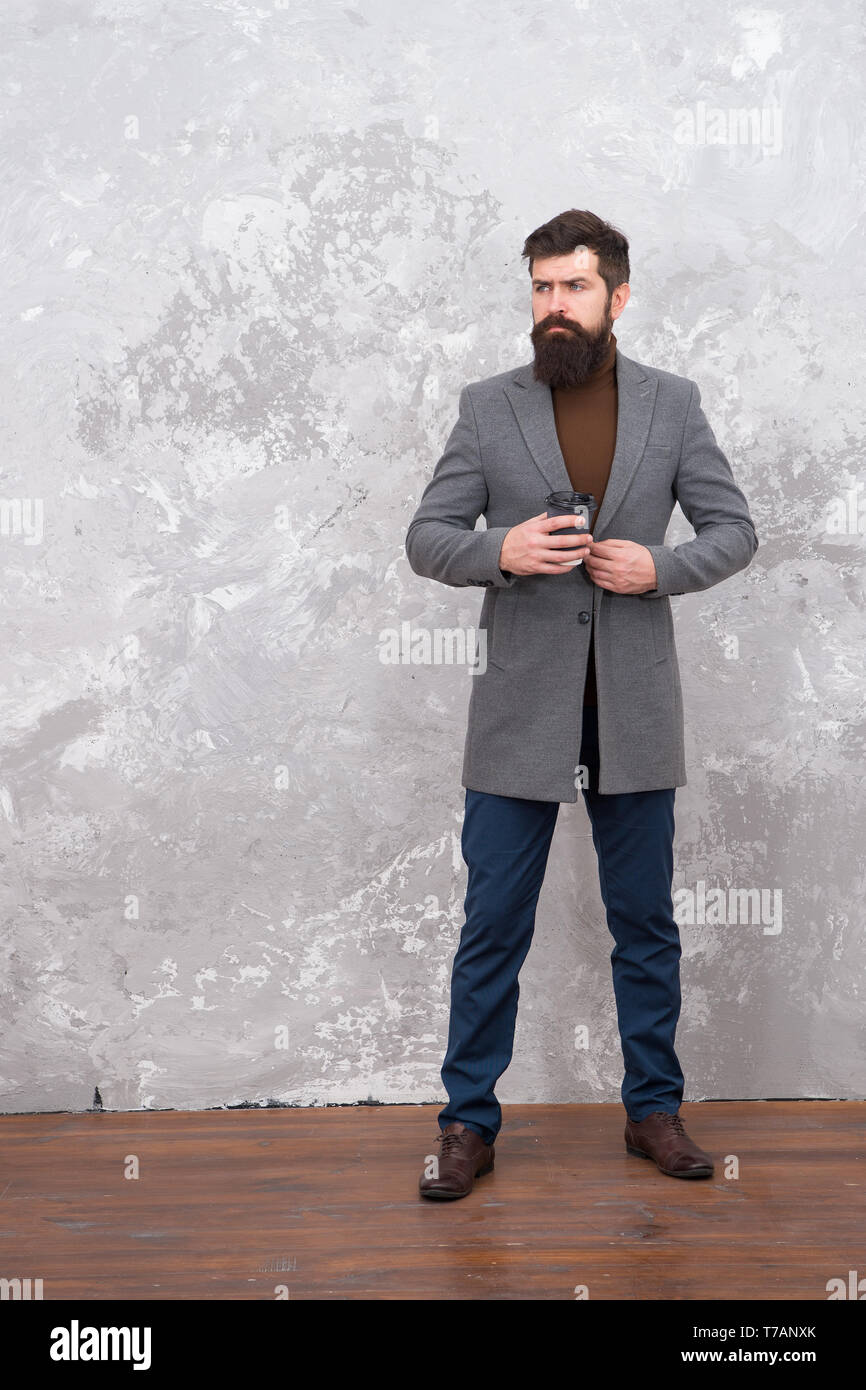 Just relaxing. Brutal bearded hipster in denim wear drink morning