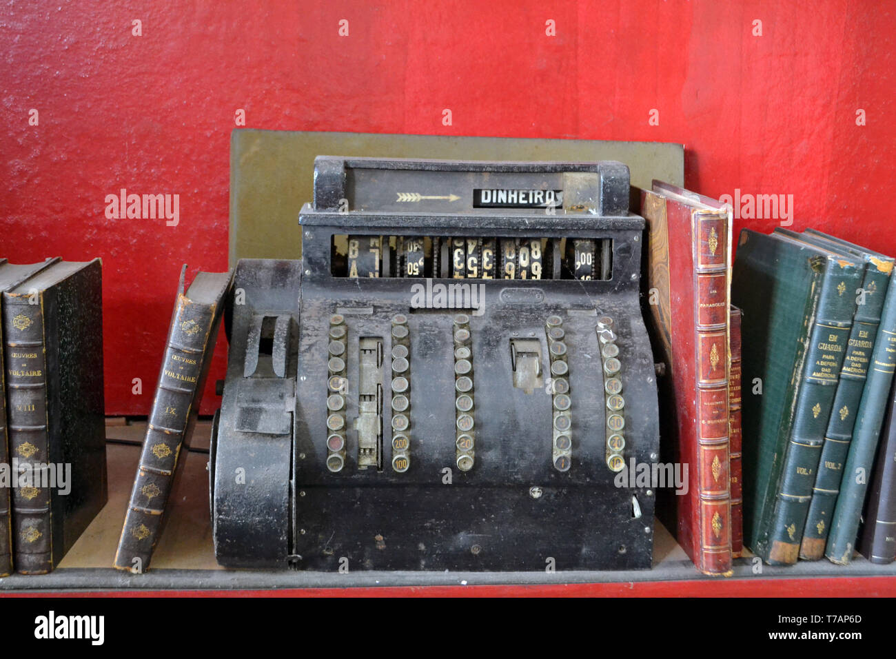 old cash register surrounded by books Stock Photo