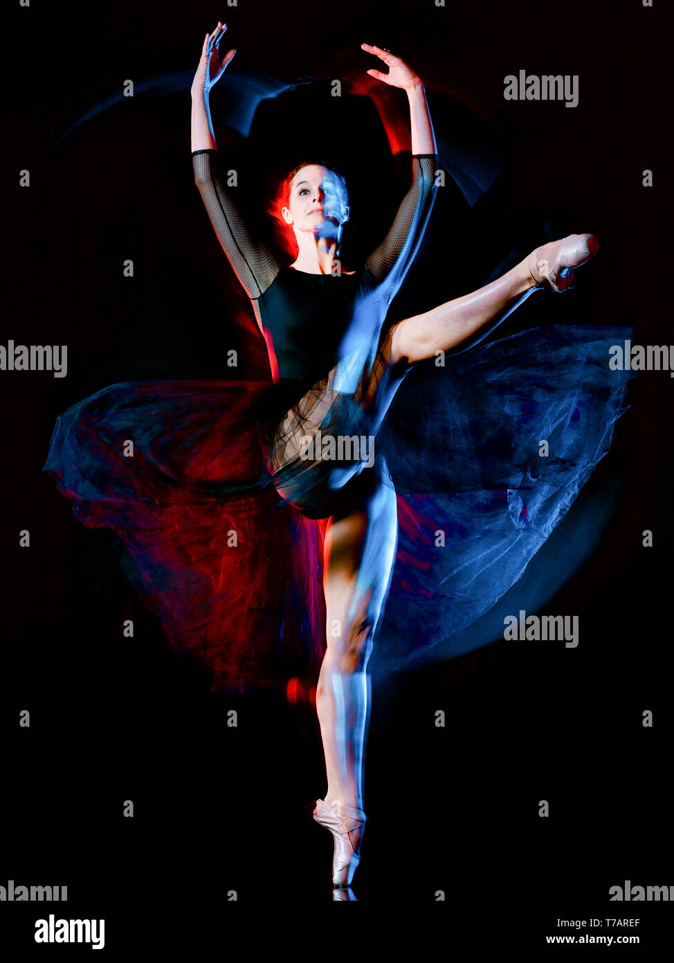 one caucasian woman ballerina classical ballet dancer dancing woman studio shot isolated on black bacground Stock Photo