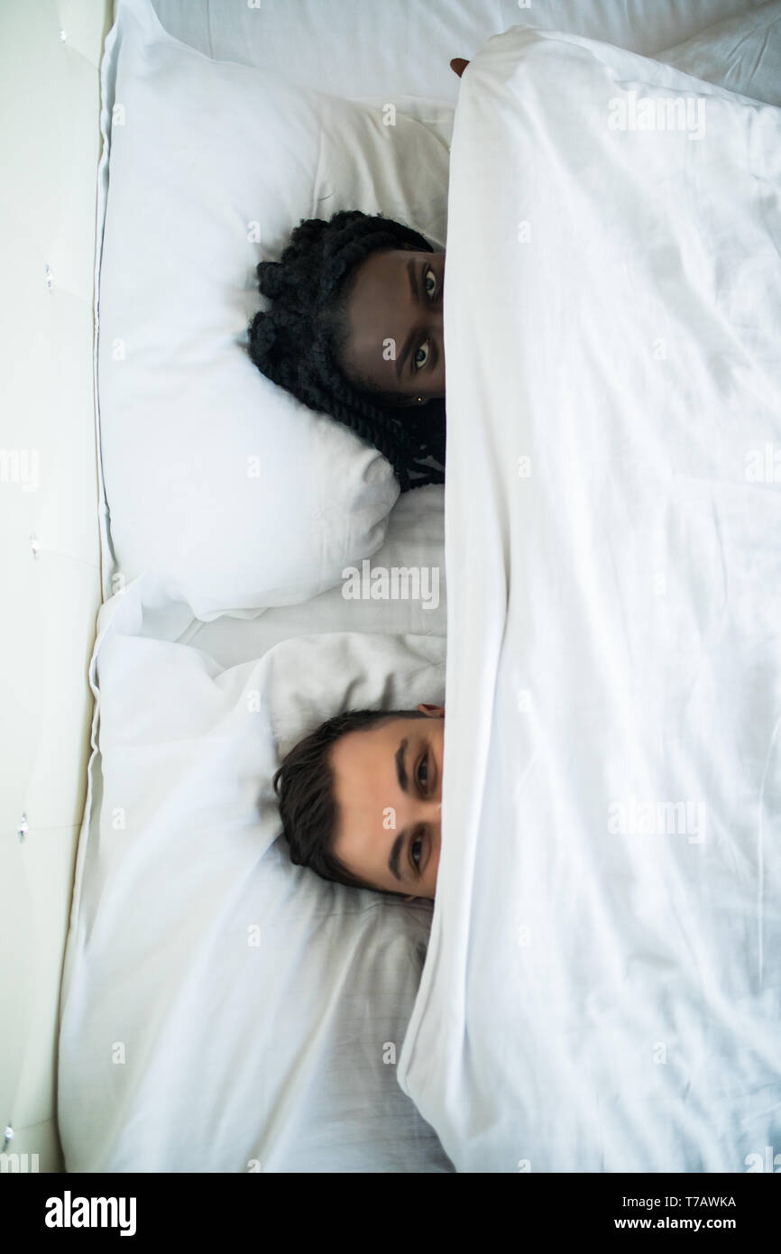 The boy and girl laugh on the bed. view from above Stock Photo Alamy