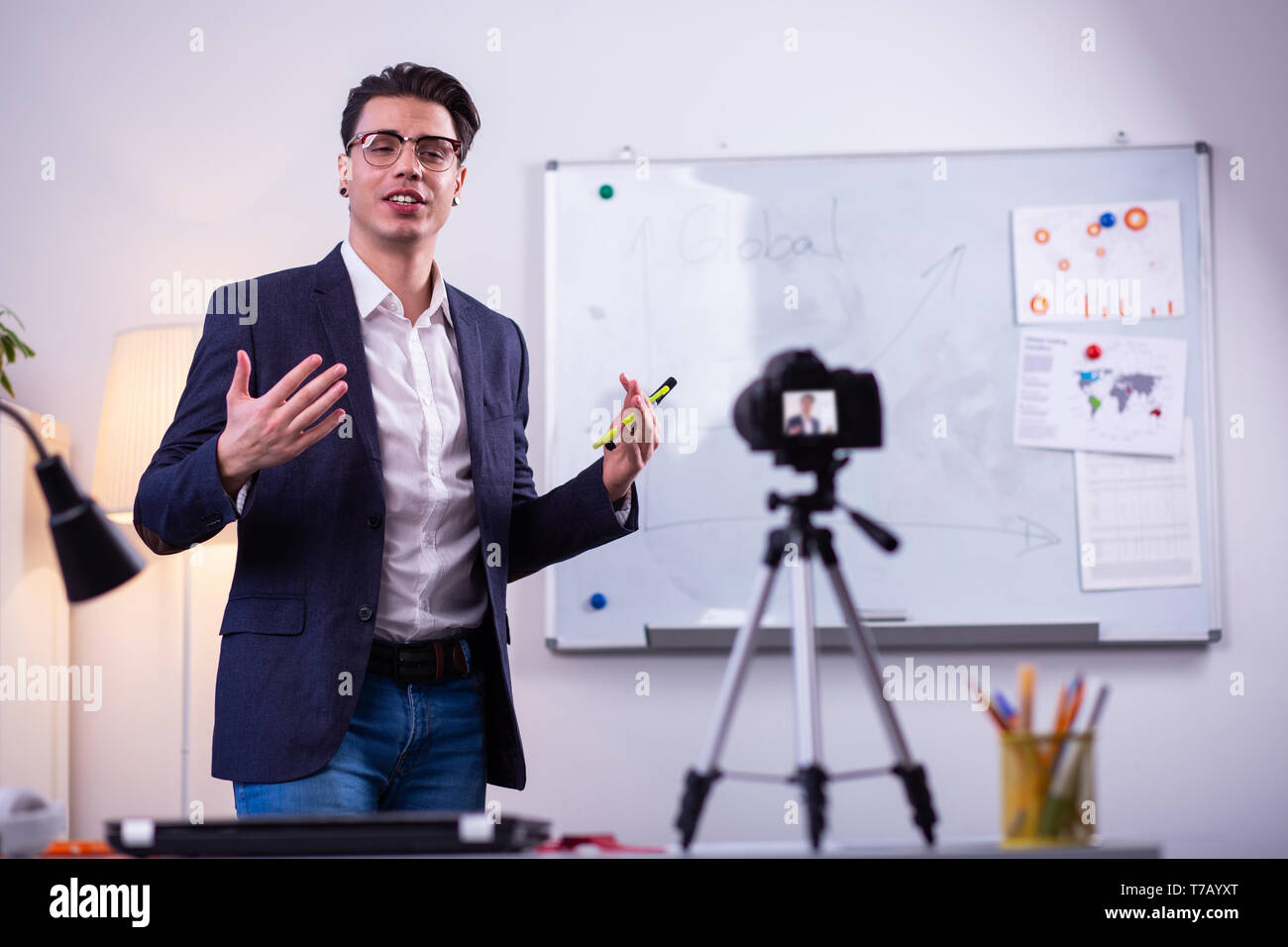 Expressive man in black neat jacket actively gesturing Stock Photo