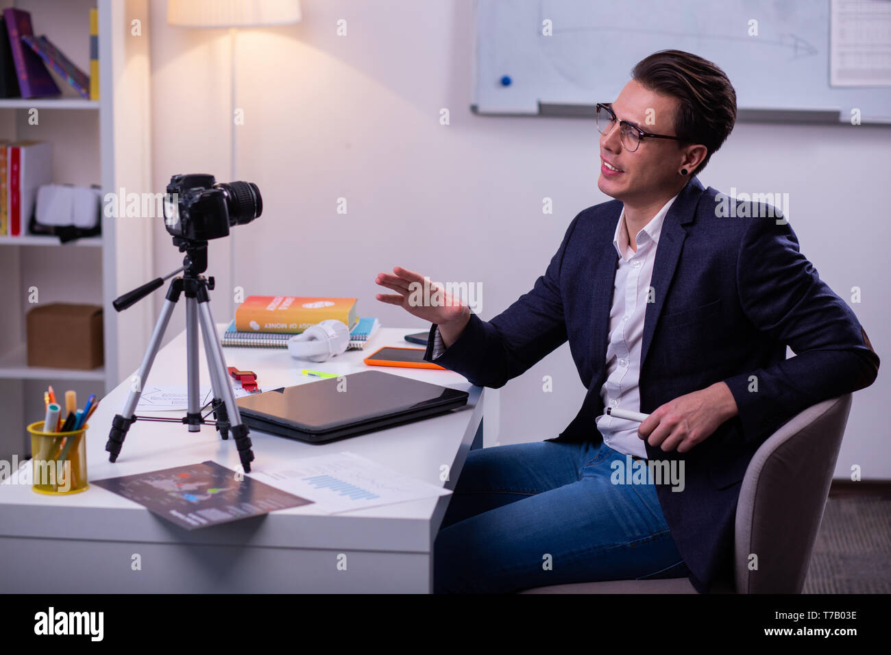 Narcissistic dark-haired businessman in clear glasses and dark jacket Stock Photo