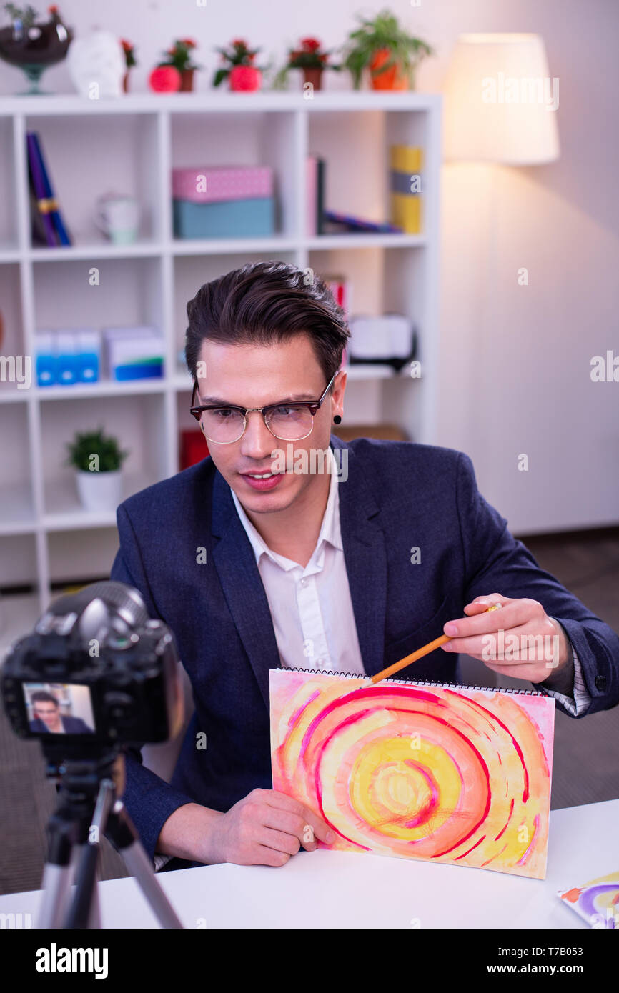 Focused online teacher creating video content on his channel Stock Photo