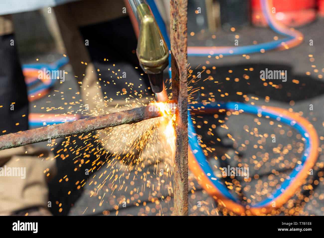 Using a gas torch to cut through wrought iron Stock Photo