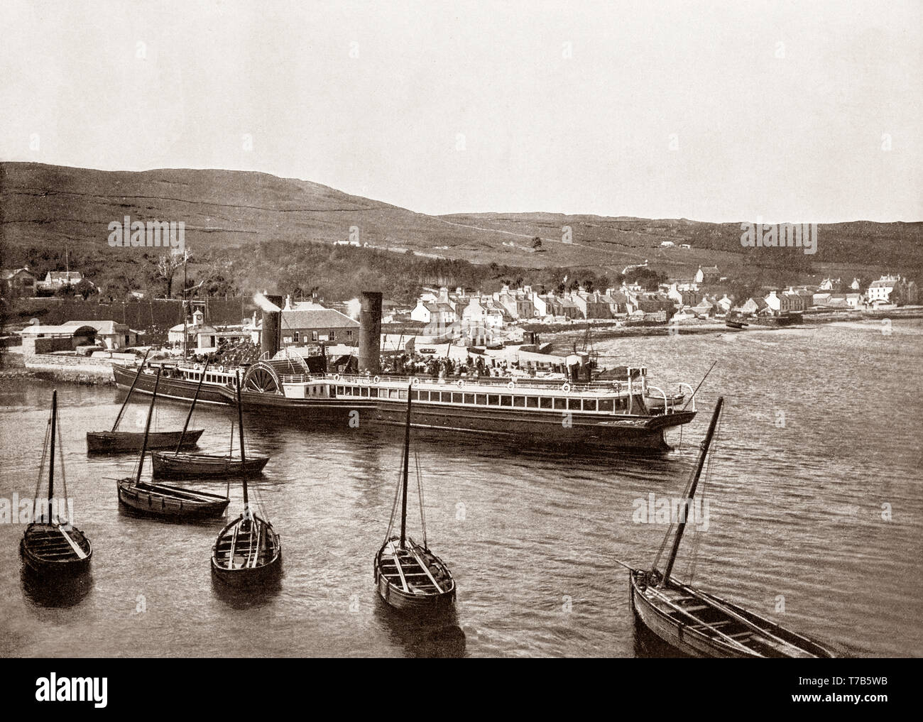 A late 19th Century view of the paddle steamer 'Columba' leaving the quay at Ardrishaig a lochside village at the southern (eastern) entrance to the Crinan Canal in Argyll and Bute in the west of Scotland. Stock Photo