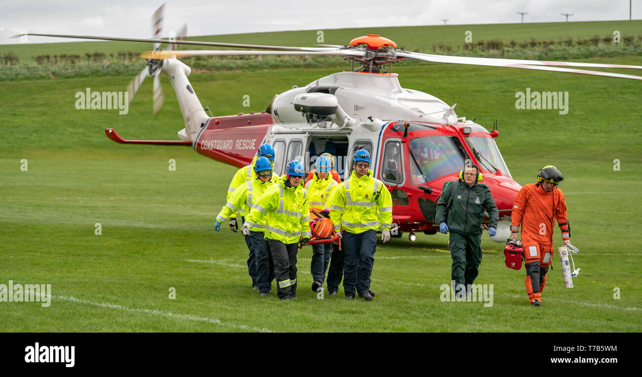 This is the rescue by HMCG (Coastguard) of a woman who fell during a charity walk and due to terrain, removed from locus by Rescue 151 Helicopter. Stock Photo