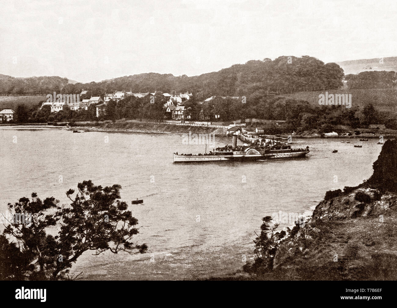 A late 19th Century view of the paddle steamer ferry 'Tantallon Castle' leaving the pier at Aberdour, a scenic and historic village on the north shore of the Firth of Forth, Fife, Scotland.  The town's harbour was improved by the addition of a stone pier to help handle the coal traffic from nearby collieries, however, during the mid-19th Century traffic changed dramatically, and Aberdour Harbour became a popular destination for pleasure steamers from Leith. Stock Photo