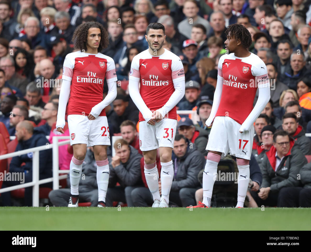London, UK. 05th May, 2019. Matteo Guendouzi (A) Sead Kolasinac (A) and Alex Iwobi (A) prepare to come on as substitutes at the Arsenal v Brighton and Hove Albion English Premier League football match at The Emirates Stadium, London, UK on May 5, 2019. **Editorial use only, license required for commercial use. No use in betting, games or a single club/league/player publications** Credit: Paul Marriott/Alamy Live News Stock Photo