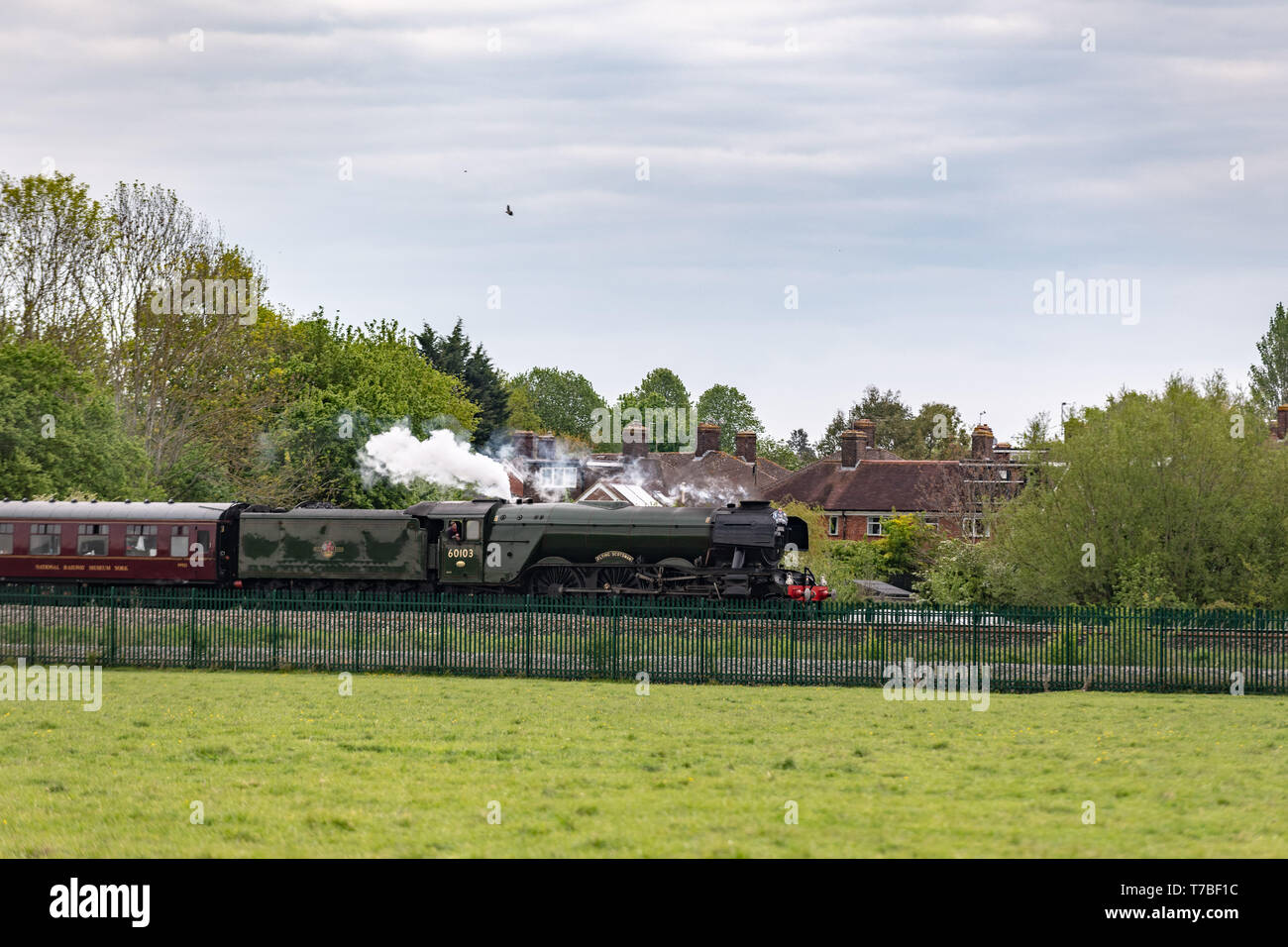 Oxford, Oxfordshire, UK. 5 May, 2019. The famous Flying Scotsman, Engine Number 60103, crosses alongside Port Meadow in Oxford Sunday evening. The train was delayed due to a broken rail and onlookers on the tracks. Credit: Sidney Bruere/Alamy Live News Stock Photo