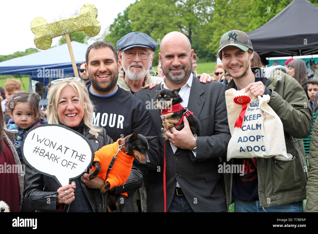 London, UK. 5th May 2019. Judges Anna Webb, Peter Egan and Marc Abraham, with Zoe the Pomchi and owner Harry, winners of the best rescue dog category (Zoe was rescued from New Mexico) at the All Dogs Matter Bark Off charity dog show, Hampstead Heath, London, England. Cute dogs took part in several categories of this annual dog show which is run by the charity which houses and rehomes dogs in London and finds homes for dogs from overseas. Dogs competed to be cutest pup, best rescue and more. More information at www.alldogsmatter.co.uk Credit: Paul Brown/Alamy Live News Stock Photo