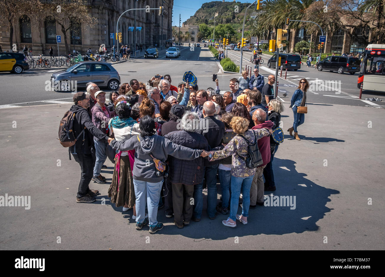 A group of protesters are seen hugging as a symbolic act during the demonstration against racism and fascism. More than 200 social groups gathered for a 'hug of the people' as part of a protest against political opposition to immigration and refugees. The rally was held in Barcelona at the foot of the Columbus monument. Stock Photo