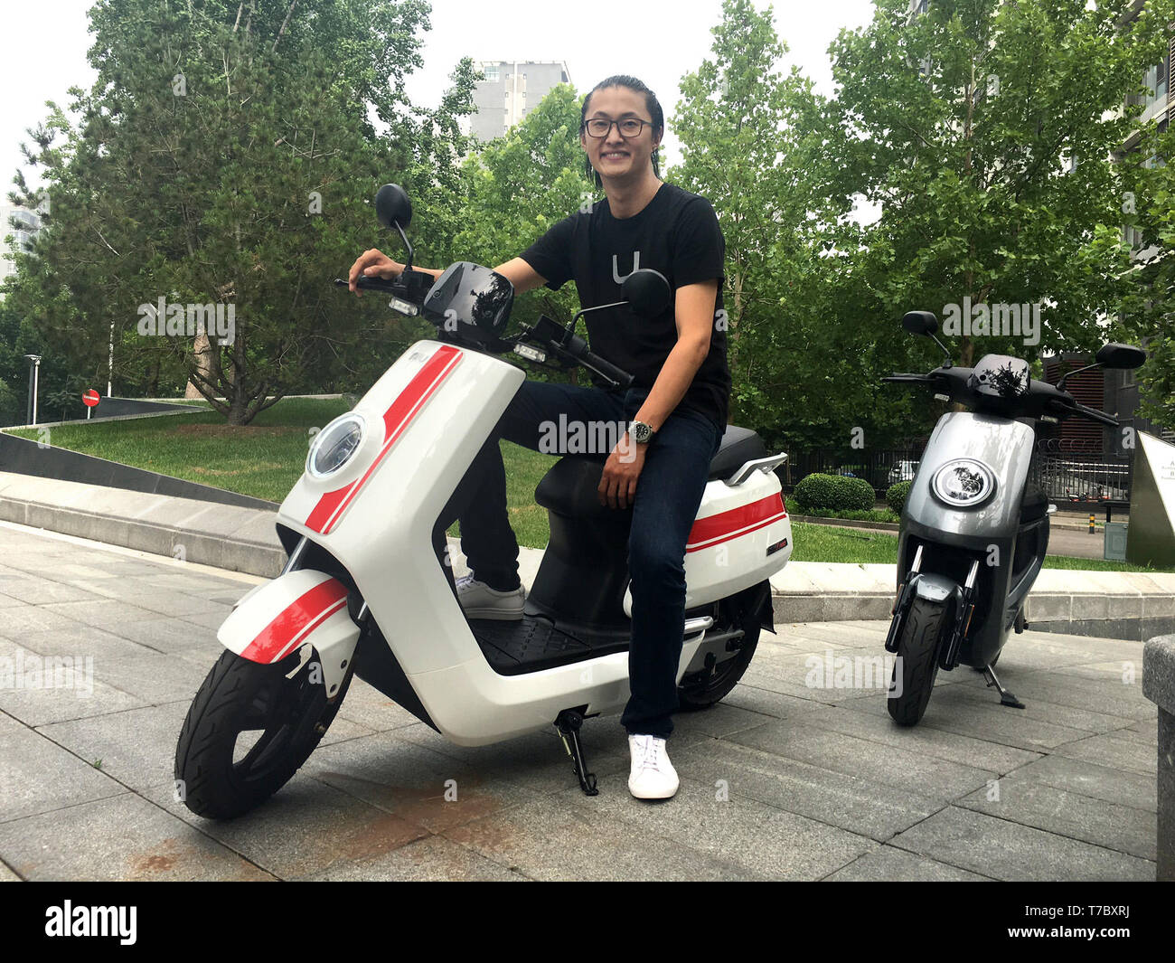 Peking, China. 05th July, 2017. Token Hu, founder of the Chinese e-roller  startup Niu, sits on a "Niu N1s pro". Volkswagen is cooperating with the  Chinese start-up Niu to enter the e-scooter