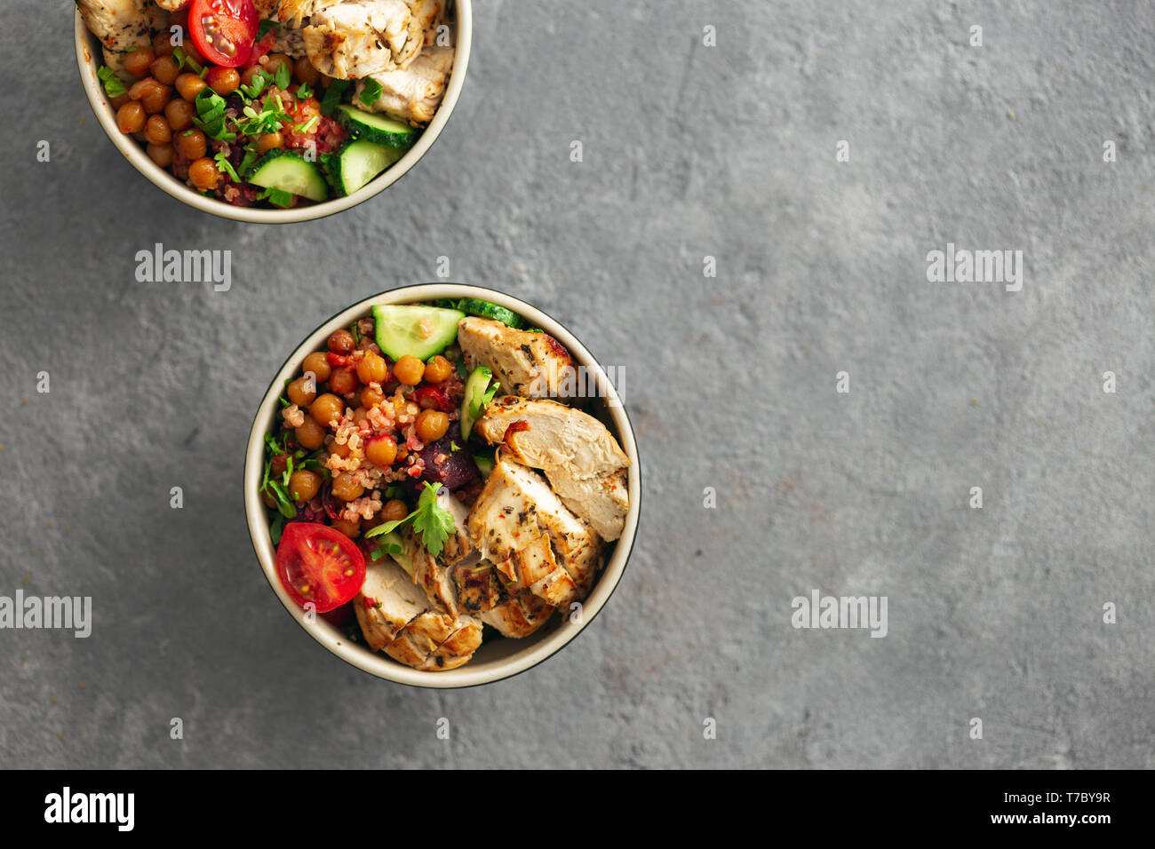 Healthy food bowl buddha top view asian table styling with copy space. Grilled chicken steak with spicy chickpeas, quinoa and baked beetroot Stock Photo