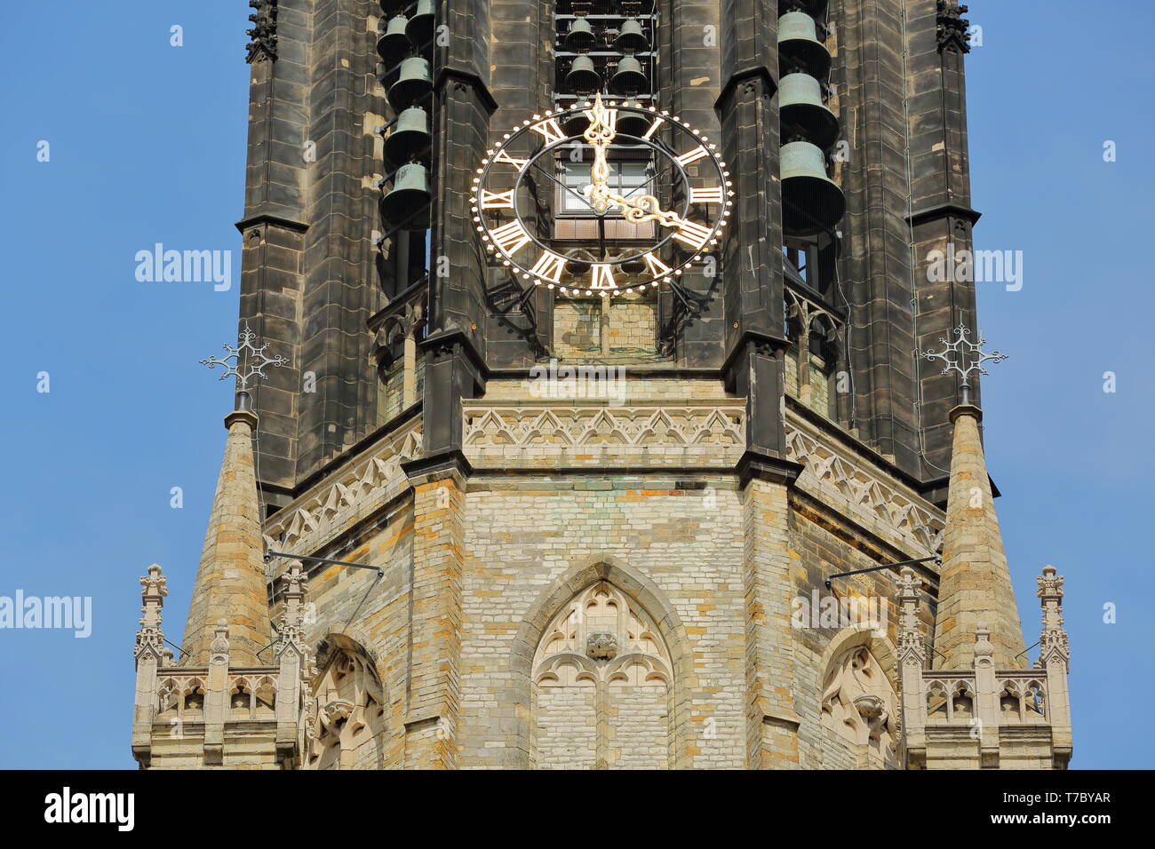 Nieuwe Kerk clock tower: close-up on clock, bells and spires, Delft, Netherlands Stock Photo