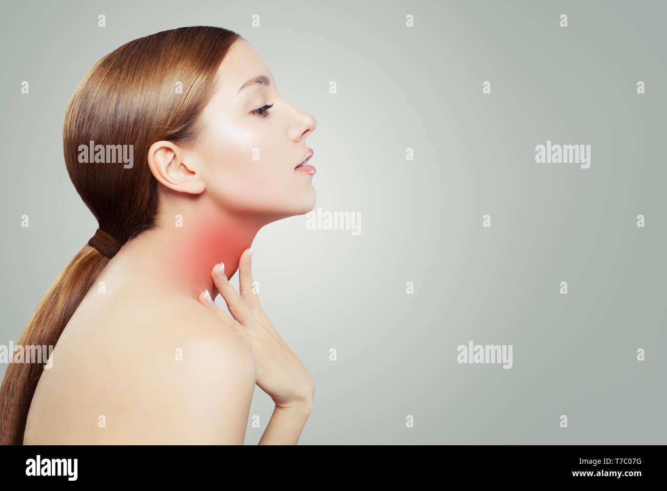 Young Woman with a Sore Throat. Woman Puts Hands on the Neck Stock