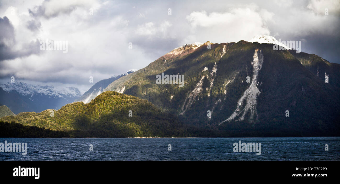Moutainous  largely unihabited forested Patagonian coastline seen from a cruise ship to the San Rafael glacier in southern Chile. Stock Photo