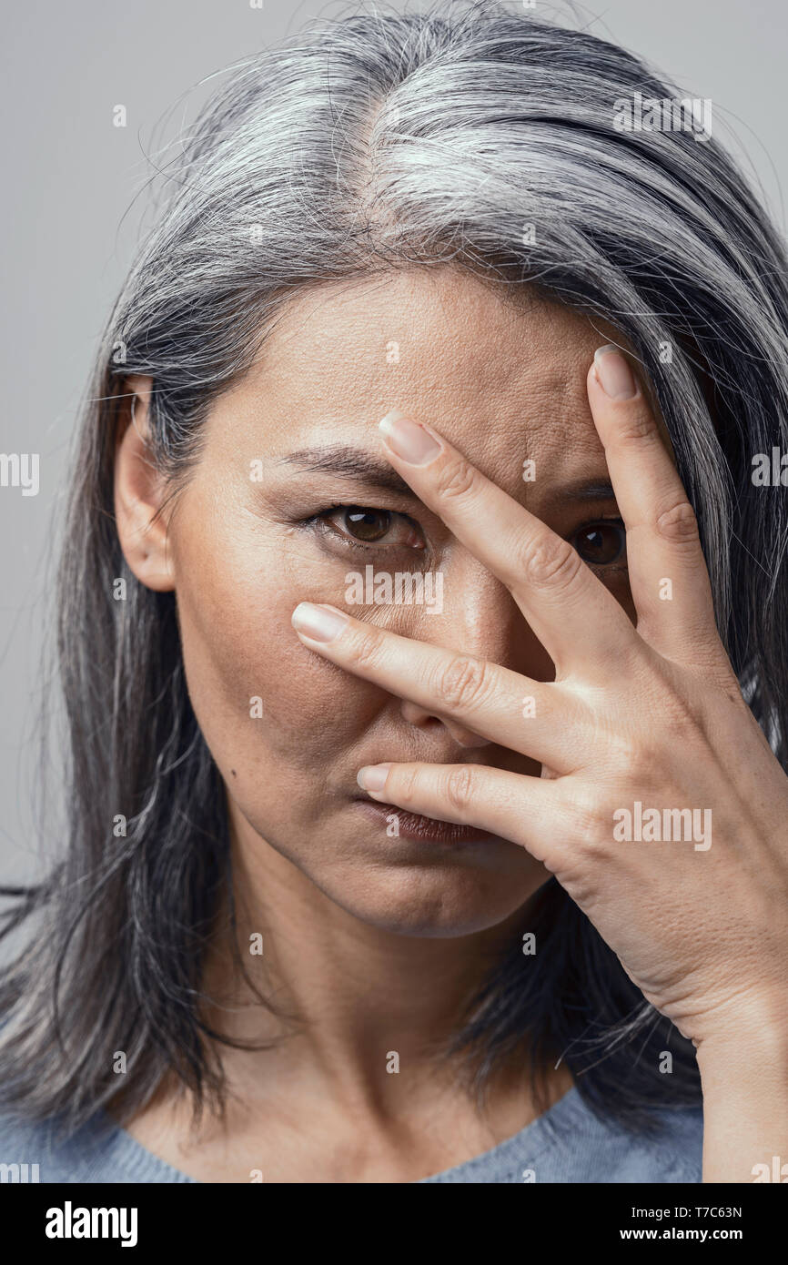 Beautiful GreyHaired Mature Asian Female With Dark Skin and Brown Eyes