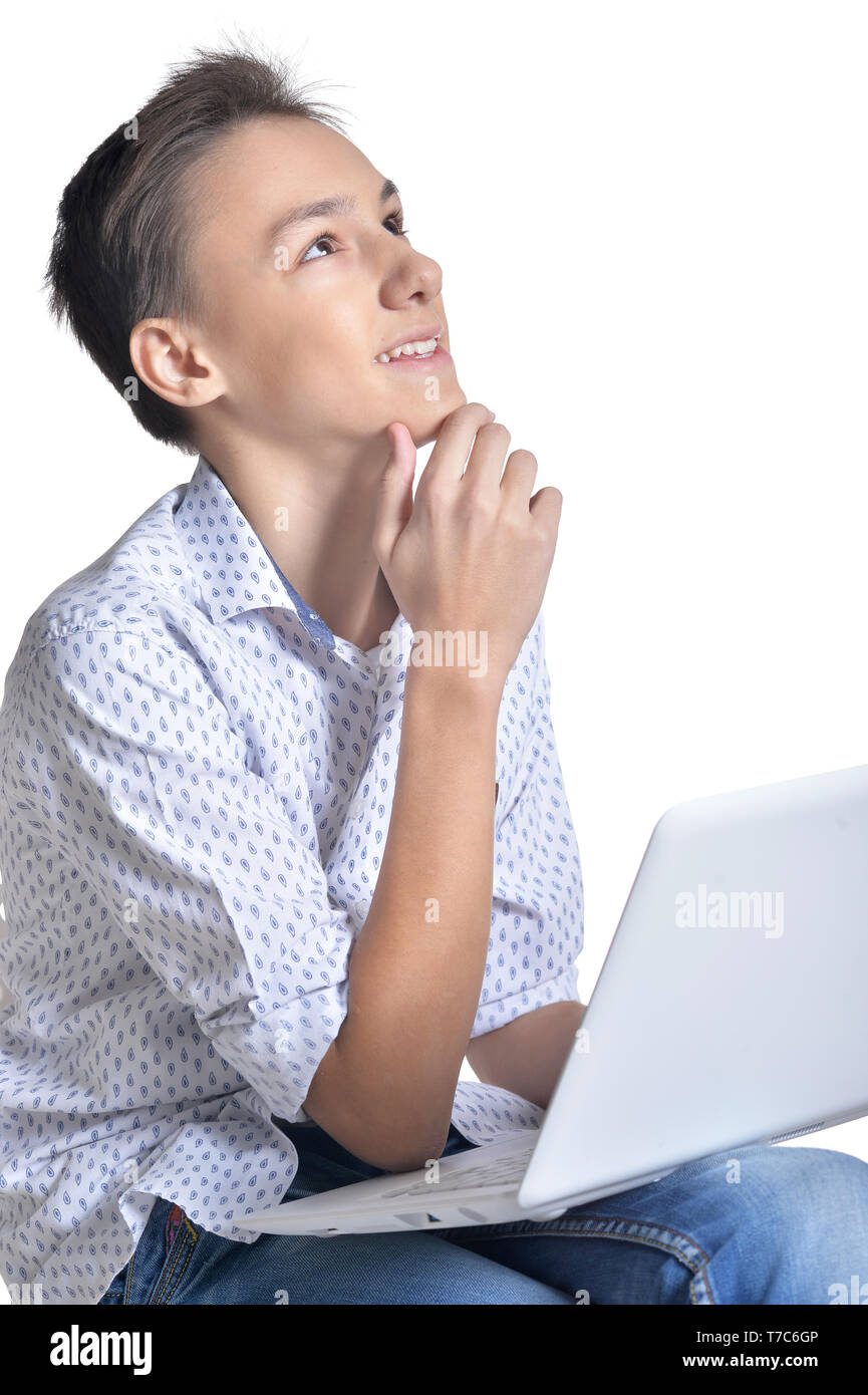 Studio portrait of teenage boy using laptop Stock Photo - Alamy