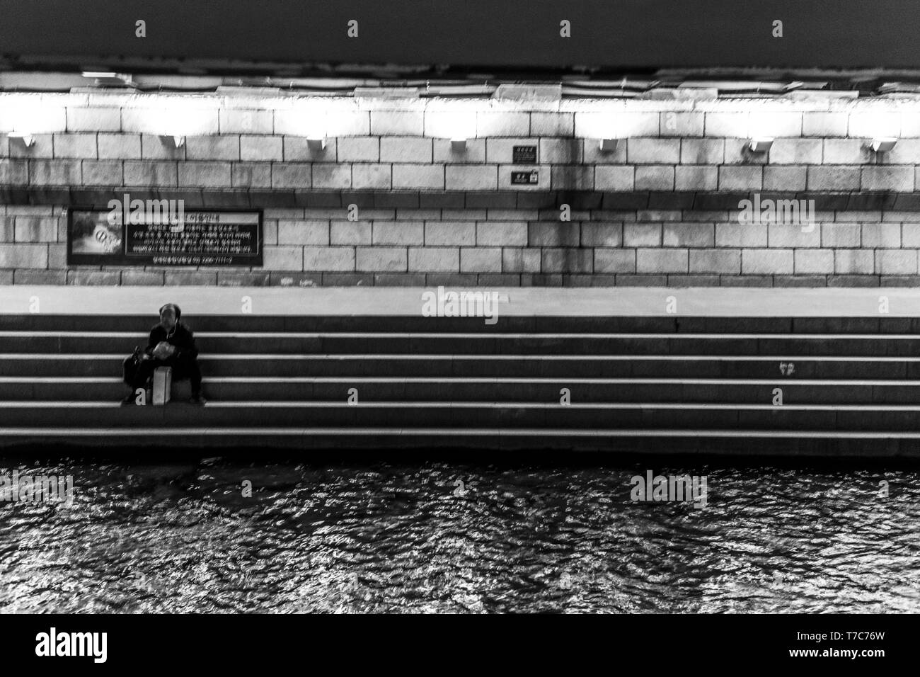 lonly man near the water in black and white, Seoul, South Korea Stock Photo