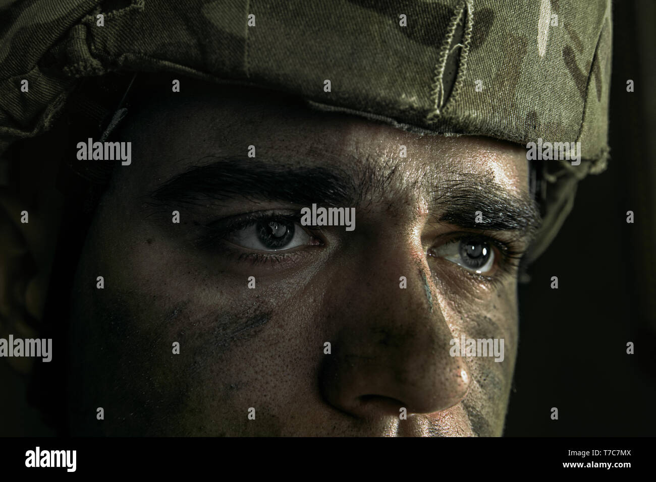 What have I do with my life. Close up portrait of young male soldier. Man in military uniform on the war. Depressed and having problems with mental health and emotions, PTSD, rehabilitation. Stock Photo
