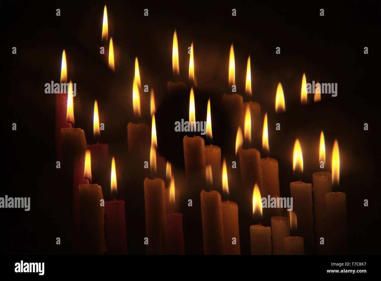 Candles flame close up on a black background Stock Photo - Alamy