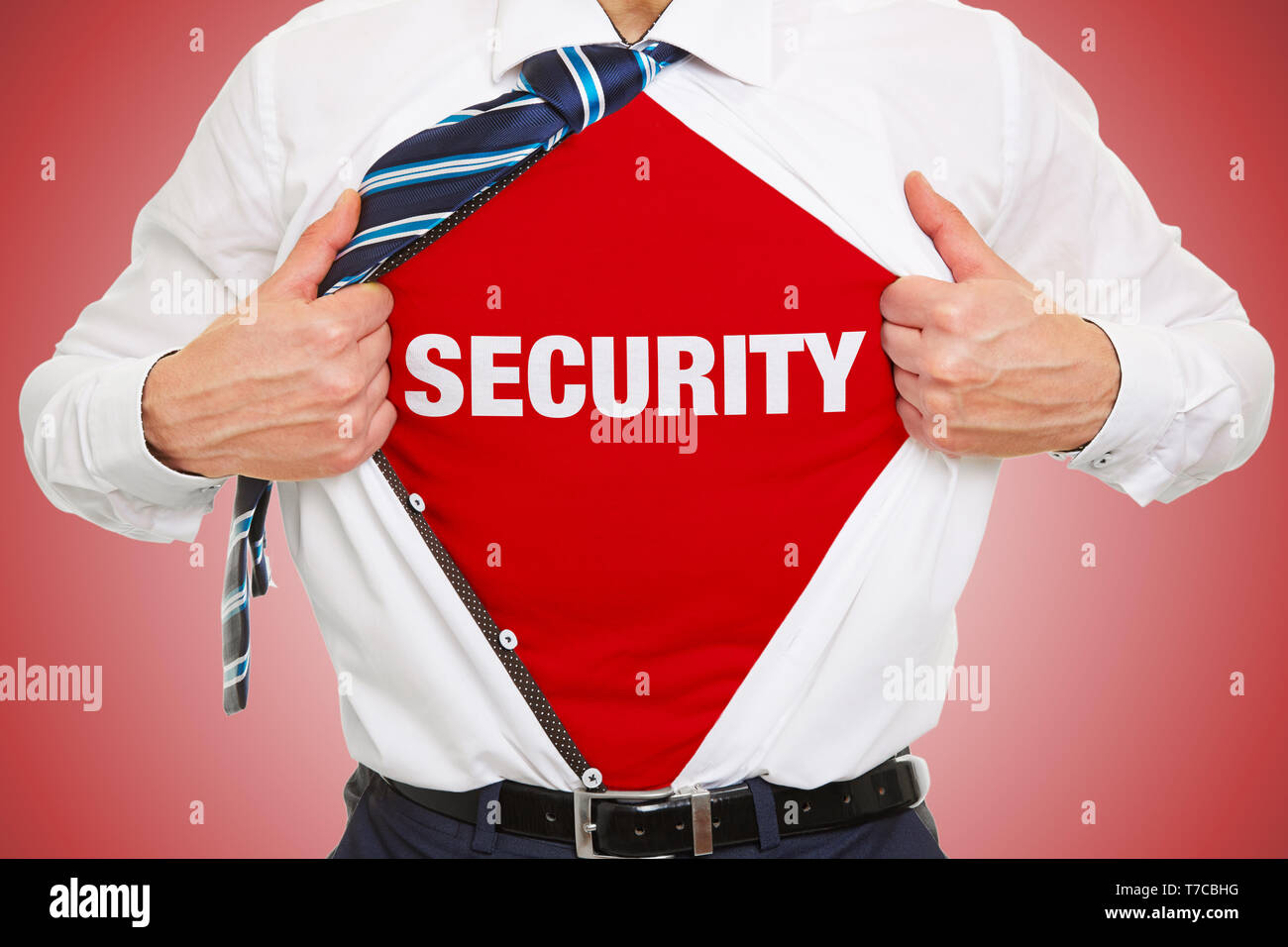 Business man opens shirt and wears lettering security underneath as security concept Stock Photo
