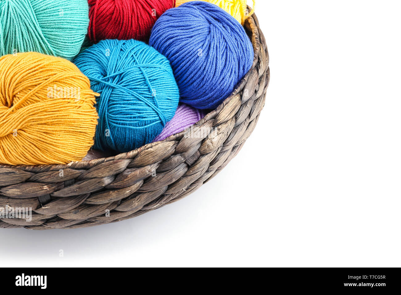 Wicker basket with balls of knitting yarn on white background Stock ...