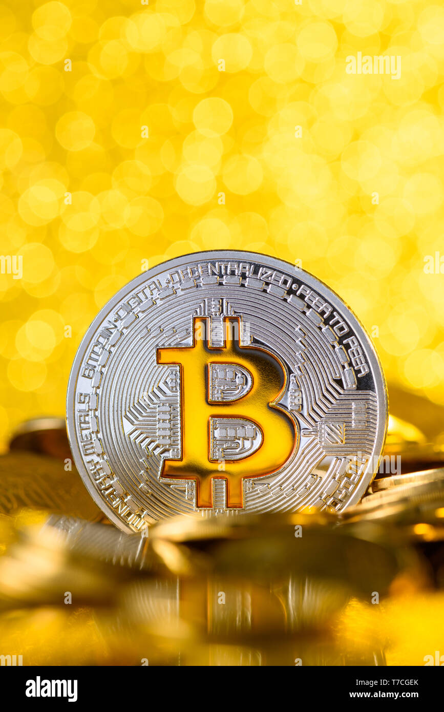 Bitcoin stands on pile of golden coins, big silver coin with gold Bit  symbol, vertical with copy space Stock Photo - Alamy