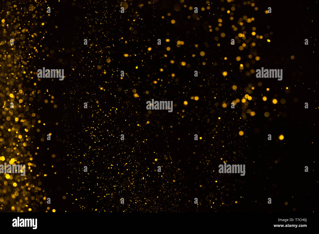 Shiny falling golden glitter dust background Stock Photo Alamy