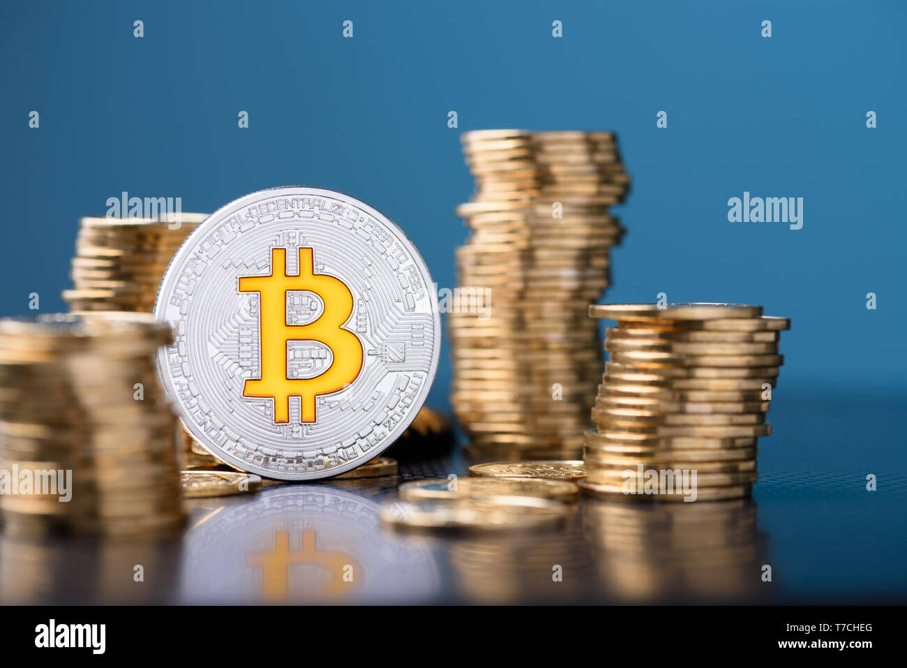 Bitcoin coin between coins stacks Stock Photo