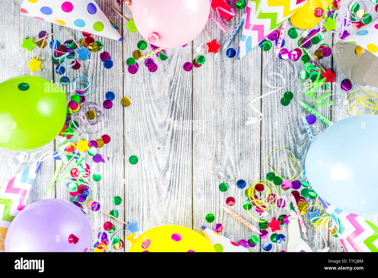 Birthday party decoration background with balloons, gift boxes, steamers and confetti, wooden