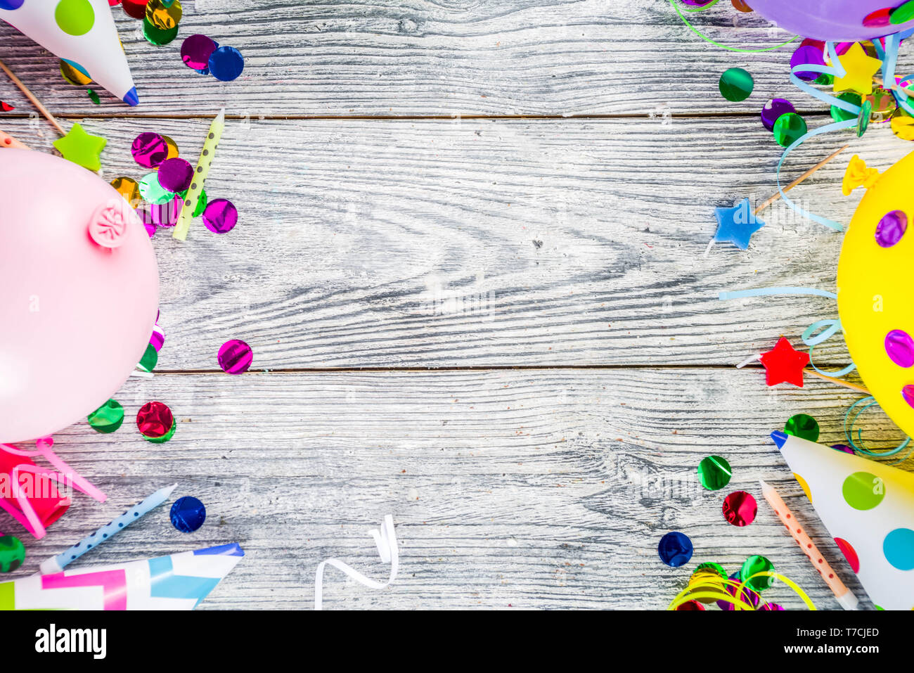 Birthday party decoration background with balloons, gift boxes, steamers and confetti, wooden