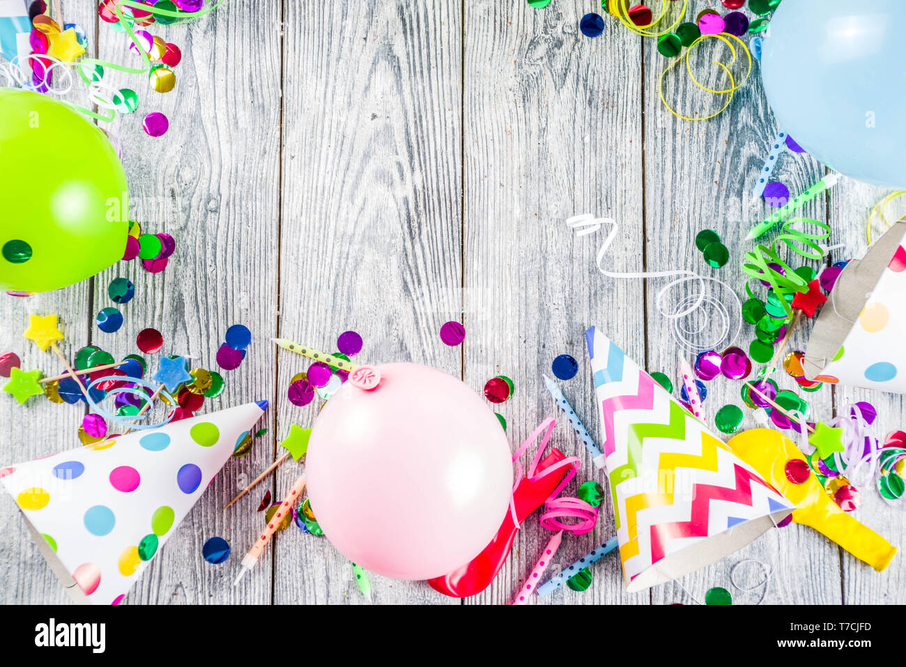 Birthday party decoration background with balloons, gift boxes, steamers and confetti, wooden