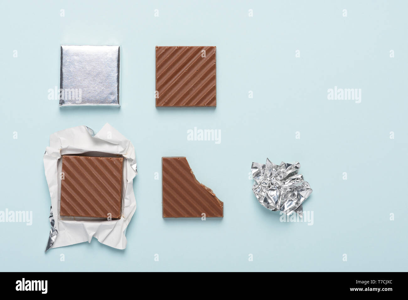 Chocolate bar life cycle on blue pastel paper background concept Stock