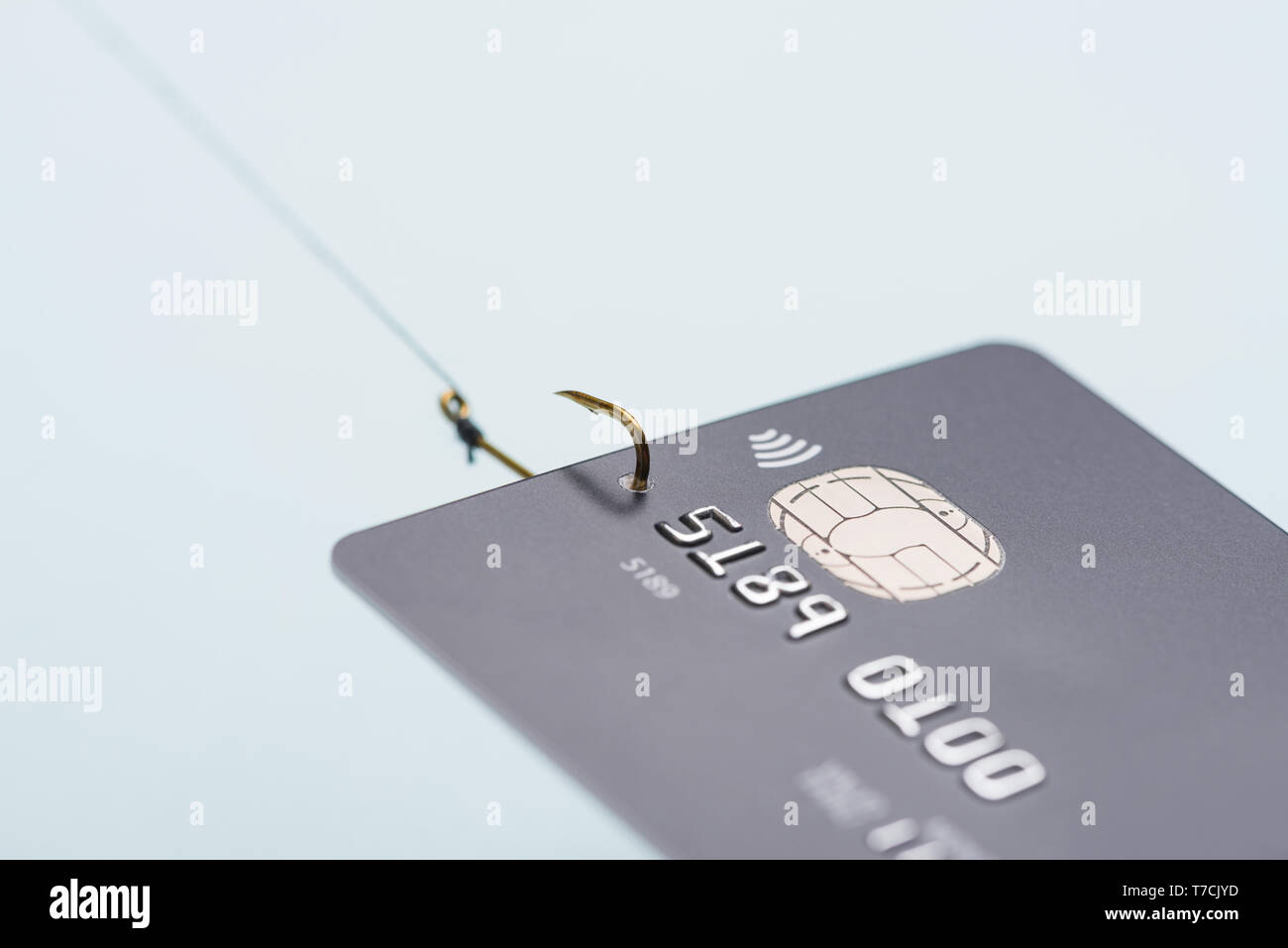 Credit card on fishing hook fraud data leak money stealing phishing concept Stock Photo