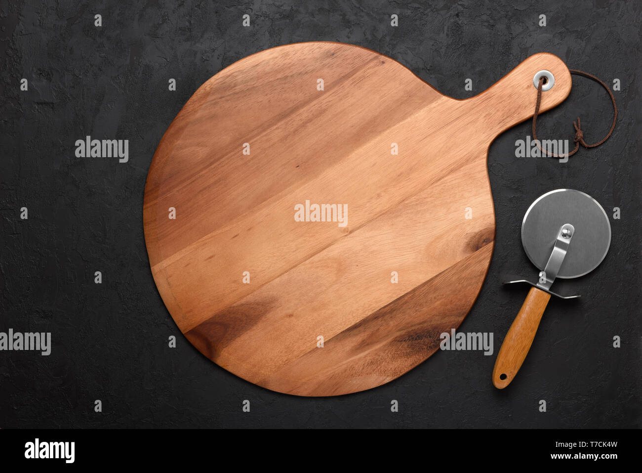 Pizza cutting board with pizza knife on dark rustic background Stock Photo