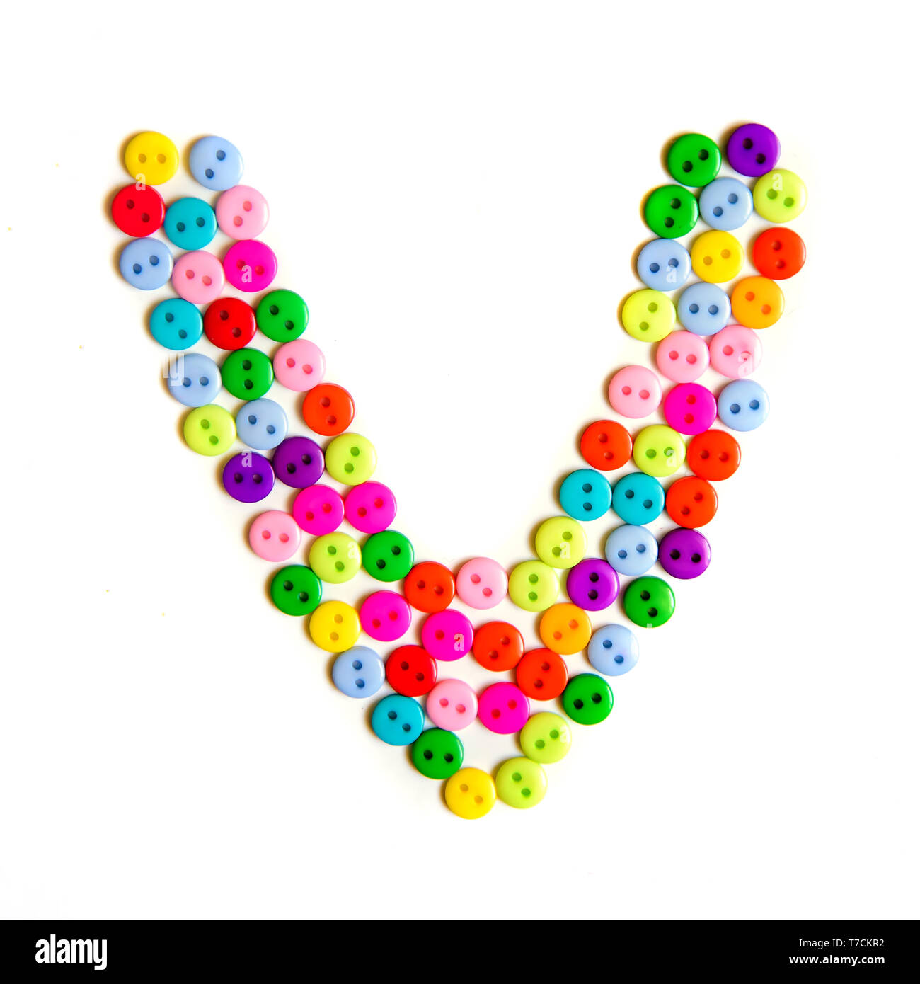 Letter V of the English alphabet from a group of colorful small buttons on a white background Stock Photo