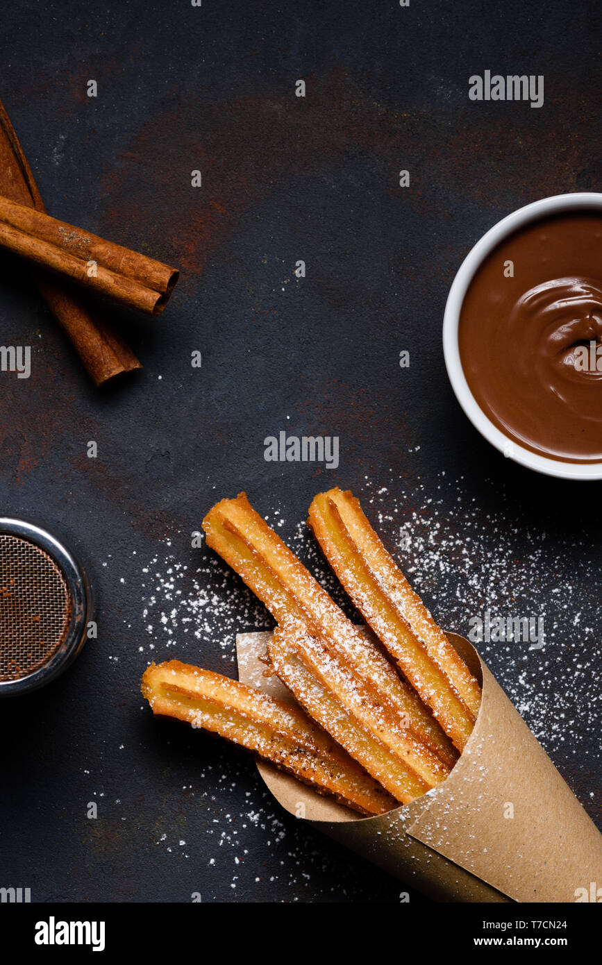 Traditional chrurro sticks hot with chocolate sausce and cinnamon flat lay copy space Stock Photo