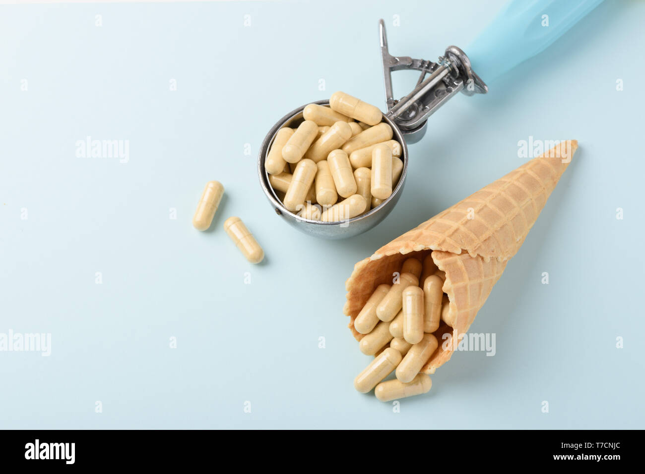 Pills drugs in ice cream scoop and waffle cone concept Stock Photo Alamy