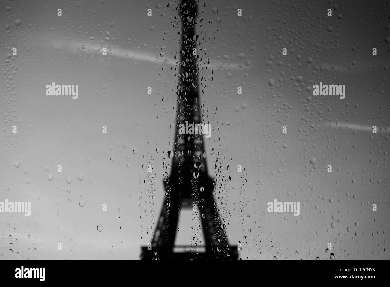 Eiffel Tower through window at rainy day Stock Photo