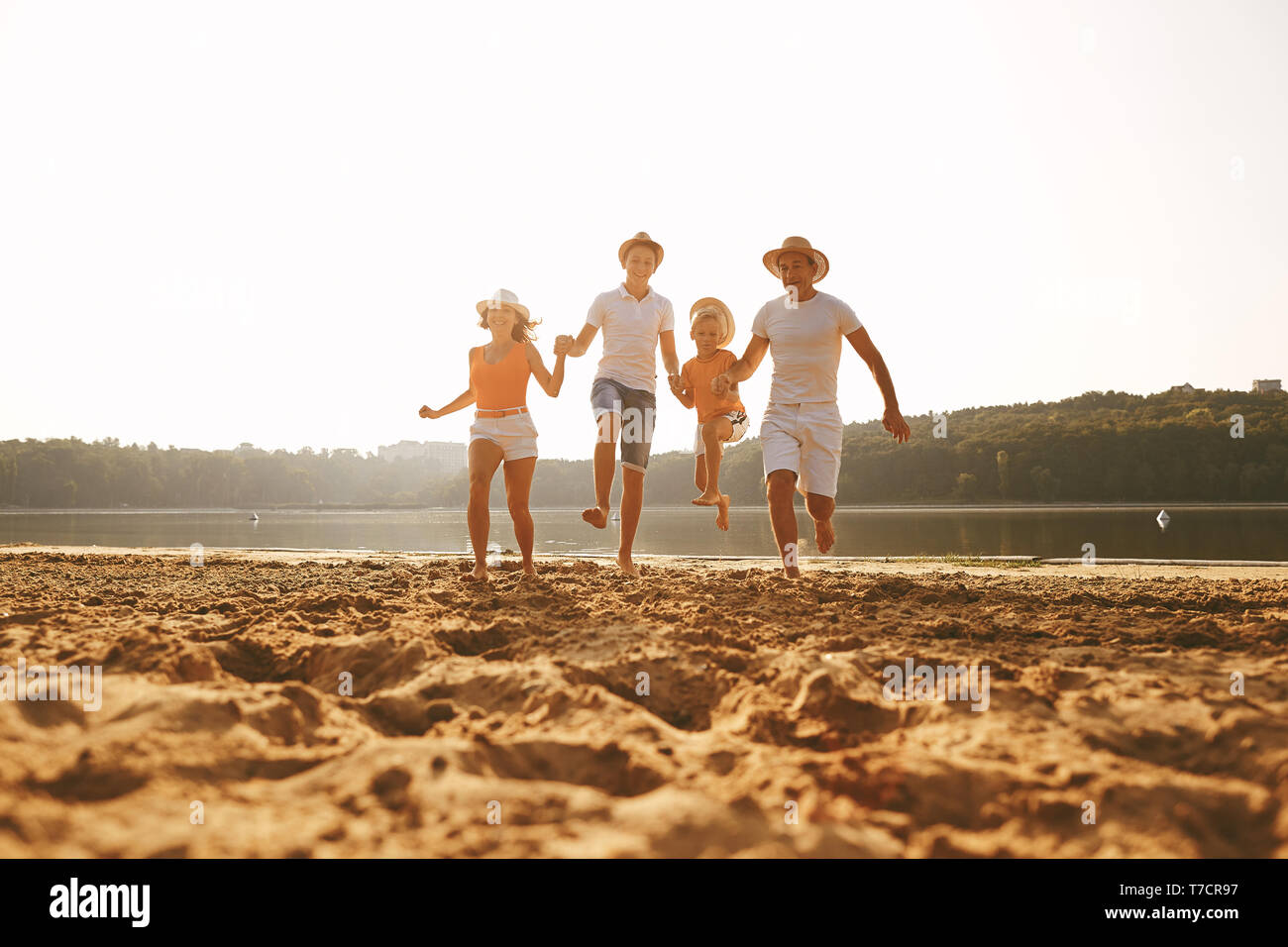 Happy family on beach playing hi-res stock photography and images - Alamy