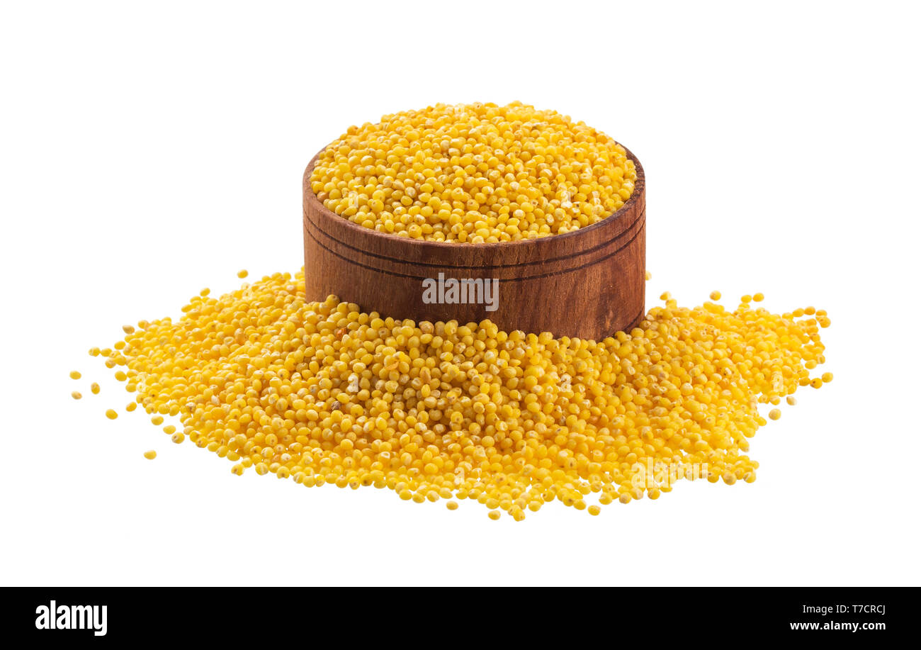 Millet seeds isolated on white background with clipping path, wooden