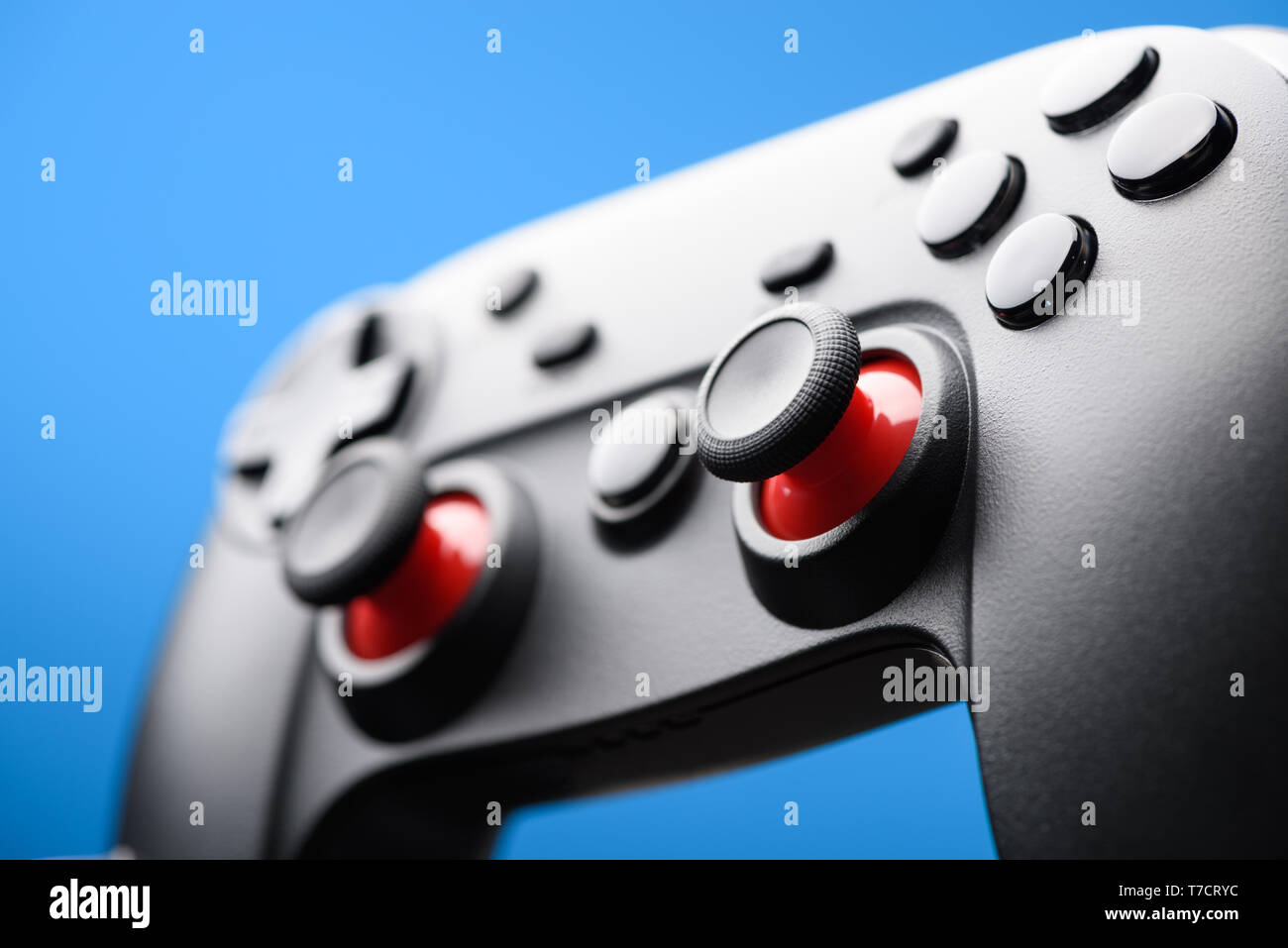 Game pad. Video game controller joy stick on blue background. Stock Photo