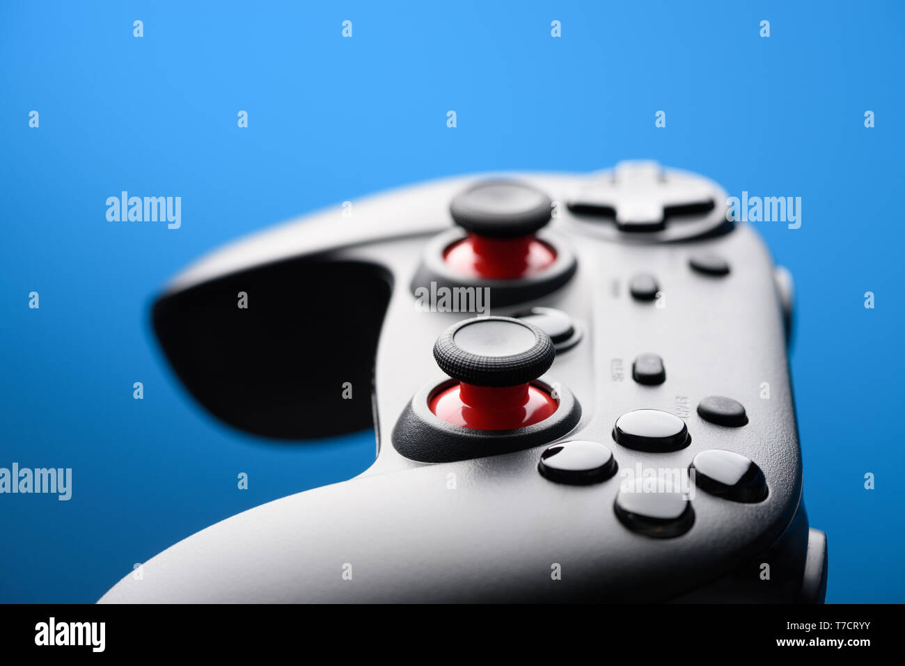 Game pad. Modern video game controller. Joy stick on blue background