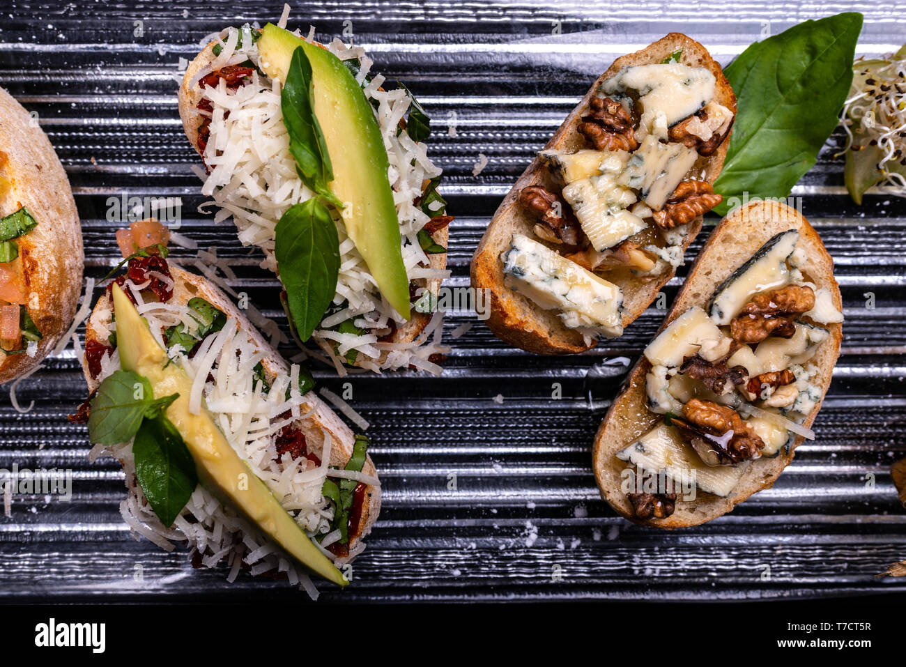 Delicious Italian antipasti bruschetta on black background. Closeup