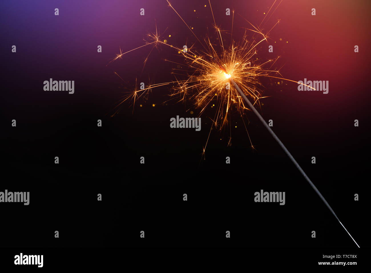 Sparkler burining glittering candle magic festive light on dark