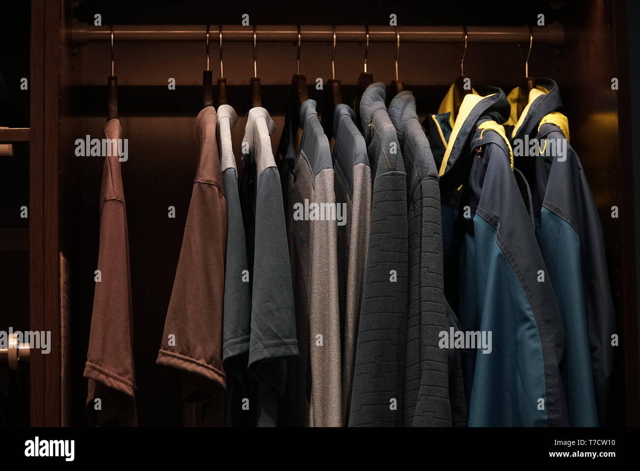 Clothes hanging in the closet on hangers, the concept of shopping or sales. Stock Photo